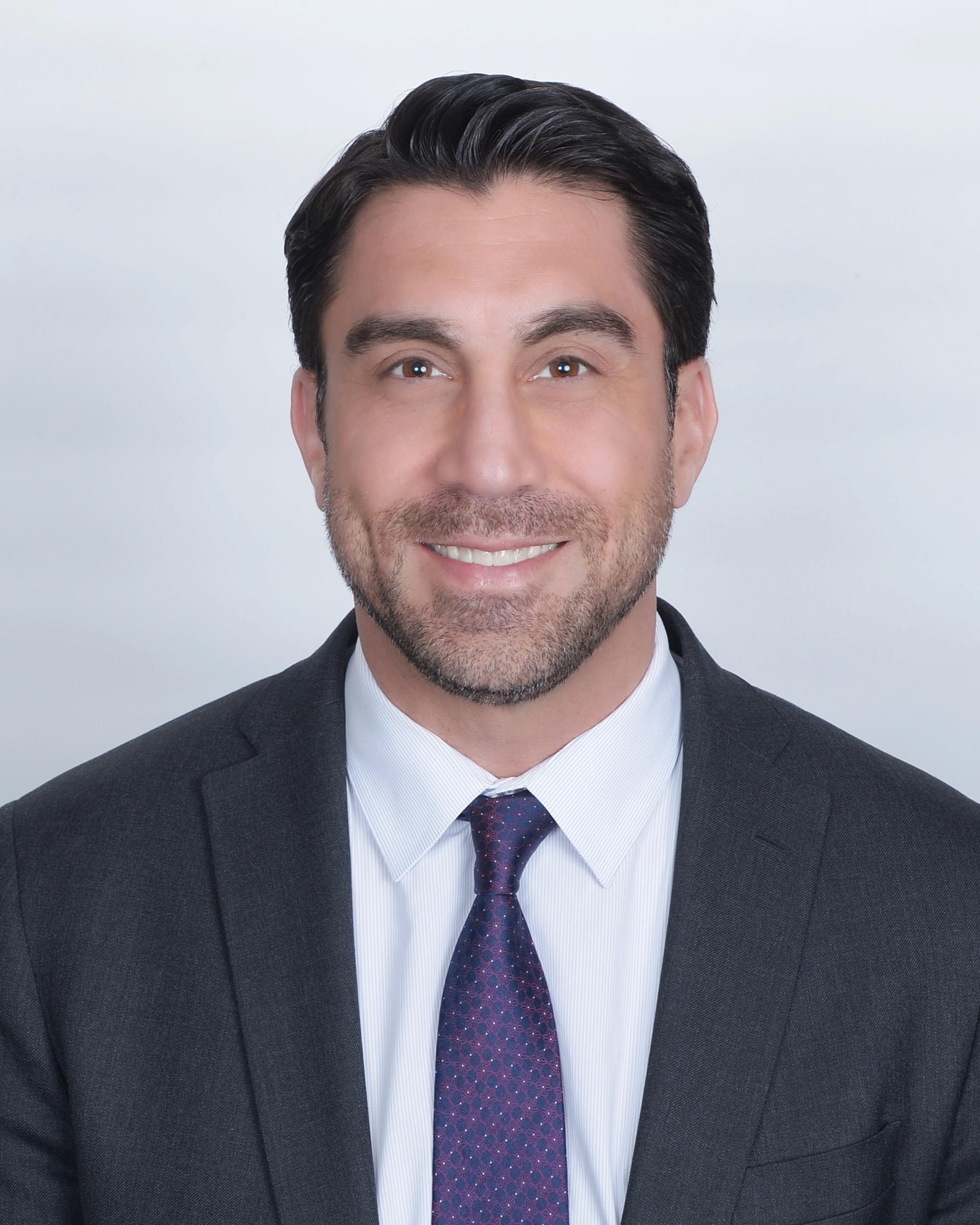 Smiling man in a suit and tie.